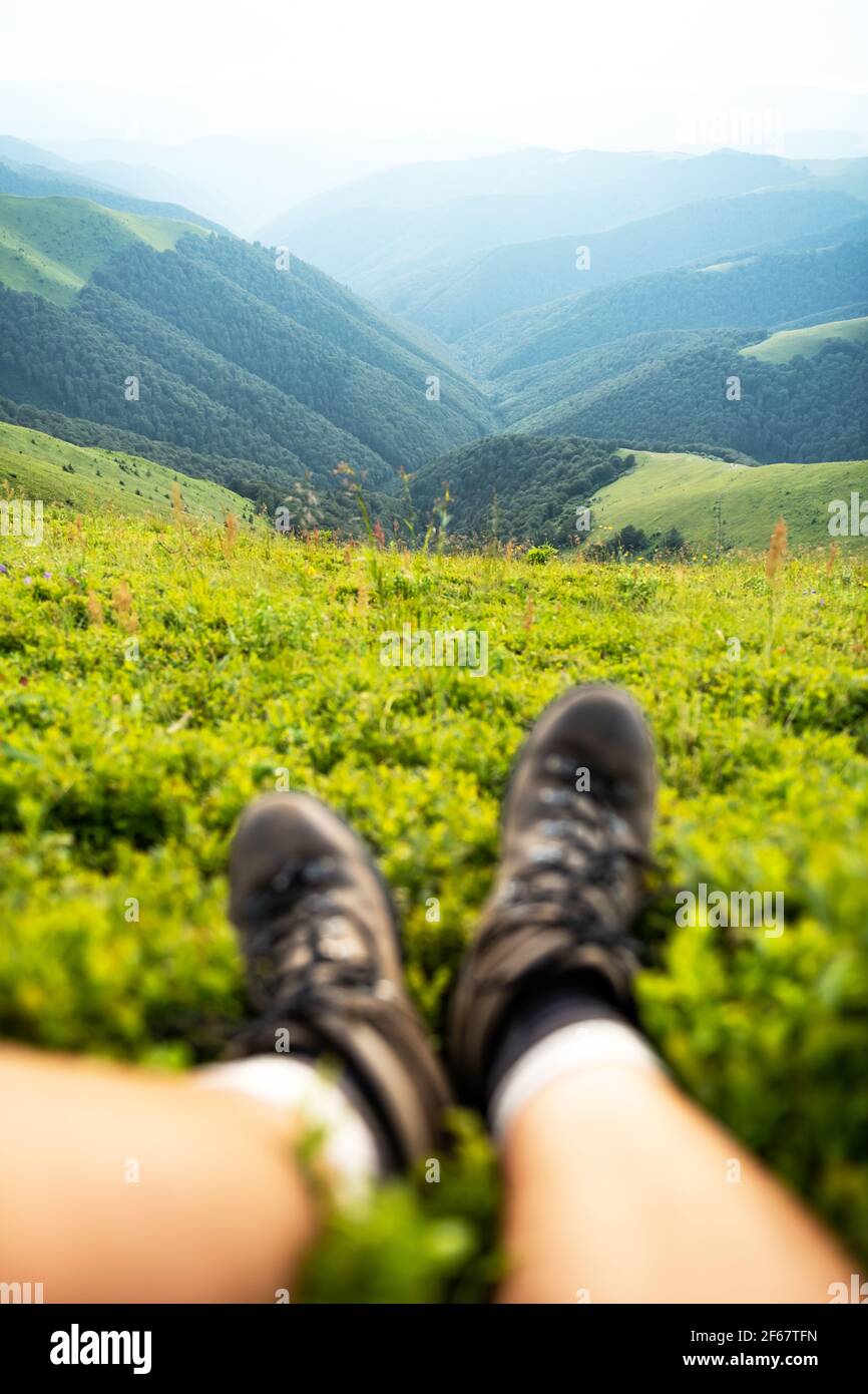 Boots of lonely tourist on lush blueberry bushs Stock Photo