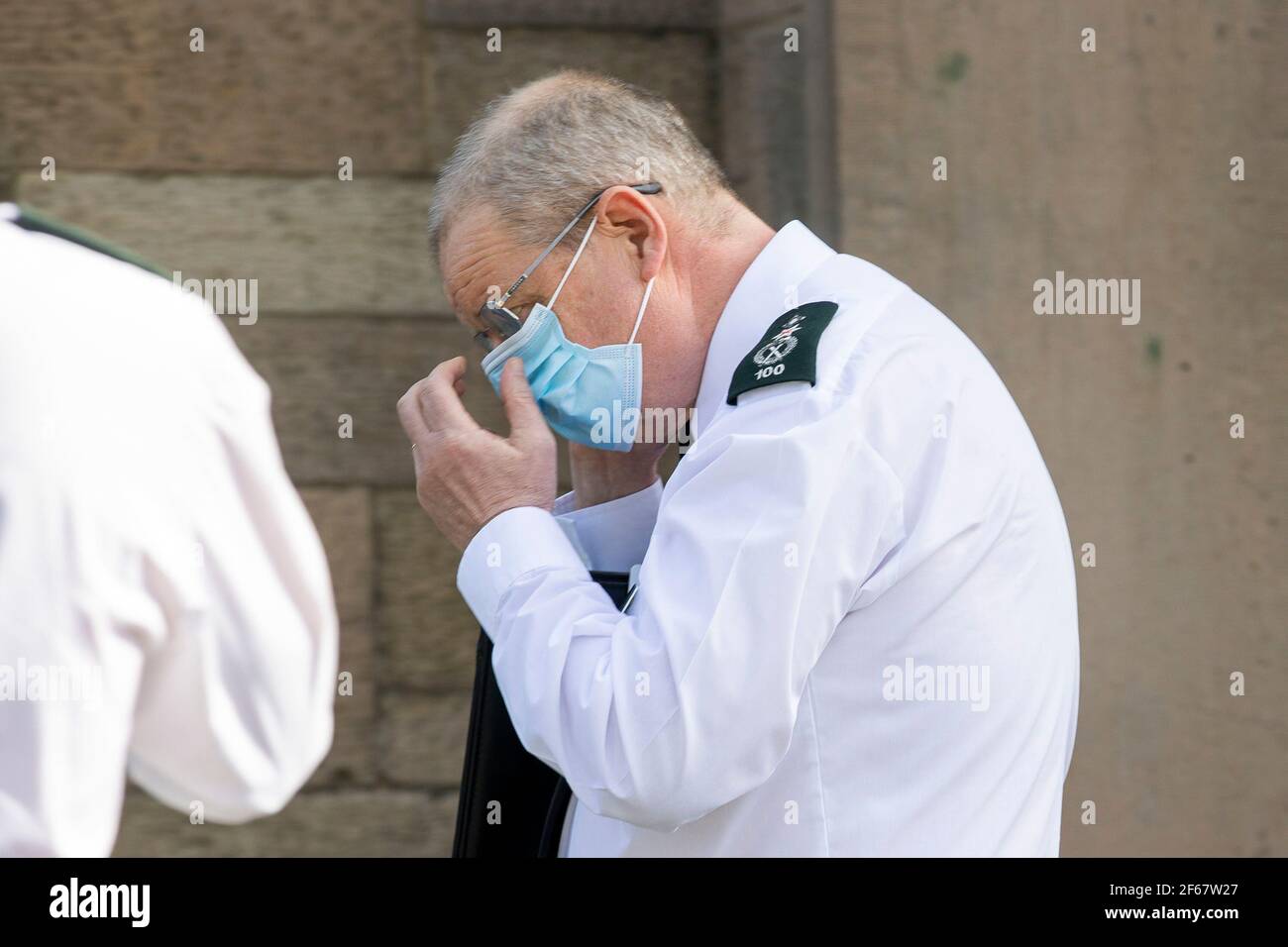 RETRANSMITTING AMENDING THE NAME BRYNE TO BYRNE. PSNI Chief Constable Simon Byrne putting on his face mask after giving reaction to the findings that the Public Prosecution Service (PPS) has not recommended prosecution for anyone concerned in relation to the funeral of prominent Irish Republican Bobby Storey in west Belfast on 30 June 2020. The funeral attracted 2,000 mourners at a time when only 30 people were permitted at public gatherings. Stock Photo