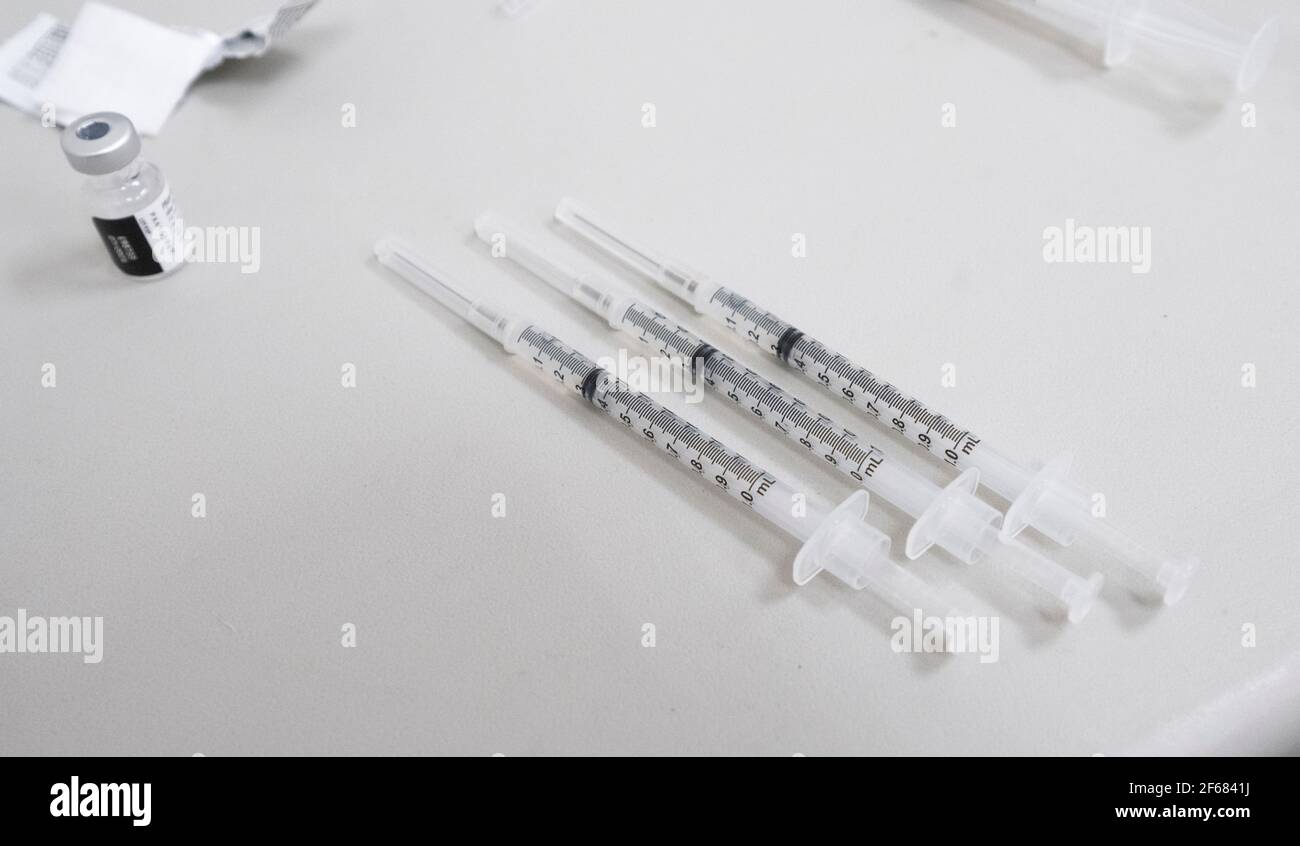 Austin, Texas March 30, 2021: Syringes containing the Pfizer vaccine on the countertop of a local pharmacy sit ready for the next patient at a neighborhood pharmacy. Texas is reporting larger shipments of vaccinations and 1 in 6 eligible Texans are fully vaccinated, around 16%. ©Bob Daemmrich Stock Photo