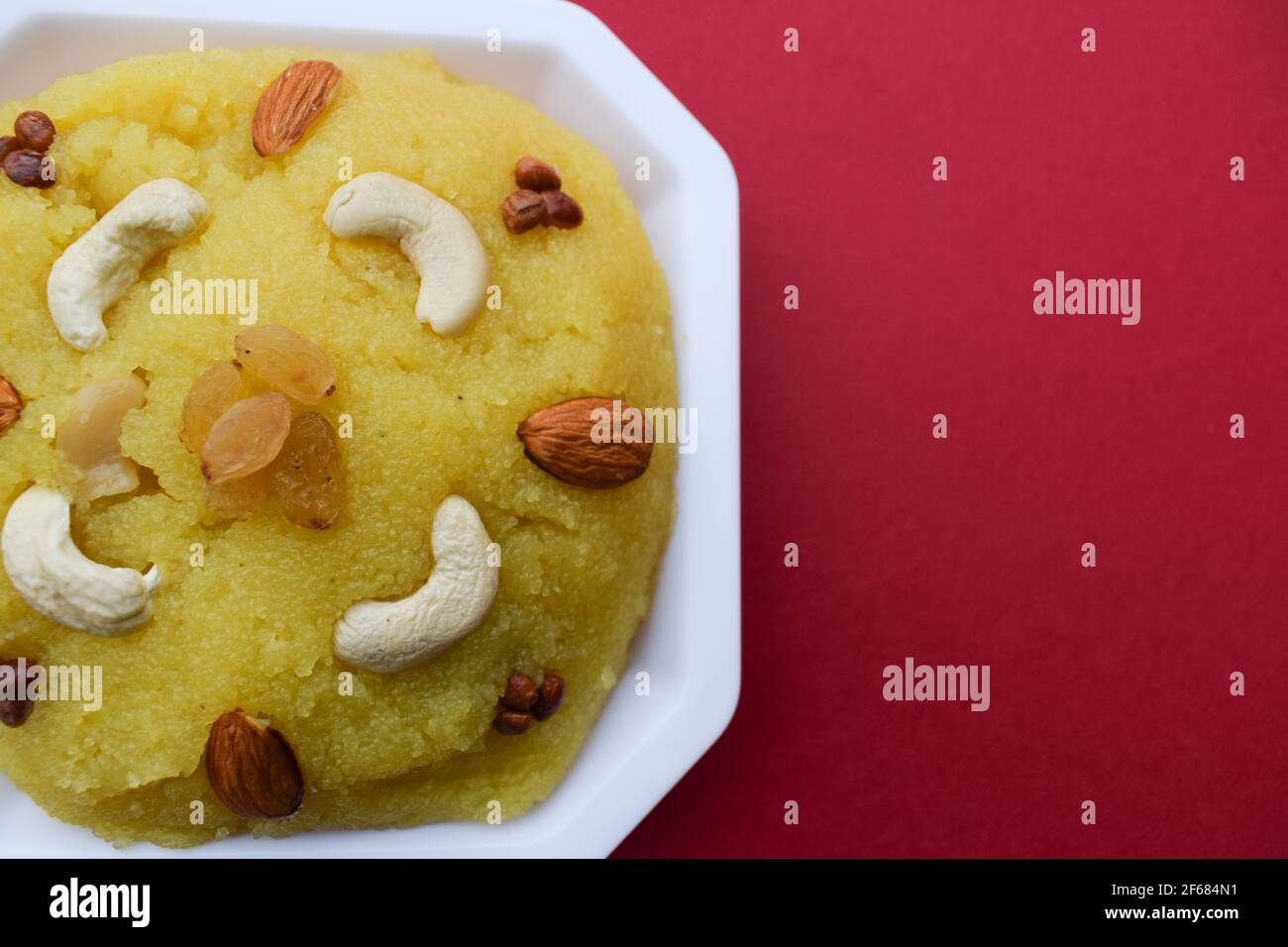 Delicious Indian and Pakistani sweet dish called Sheera or Seera prepared with desi ghee and rava garnished with dry fruits. Homemade and eaten during Stock Photo