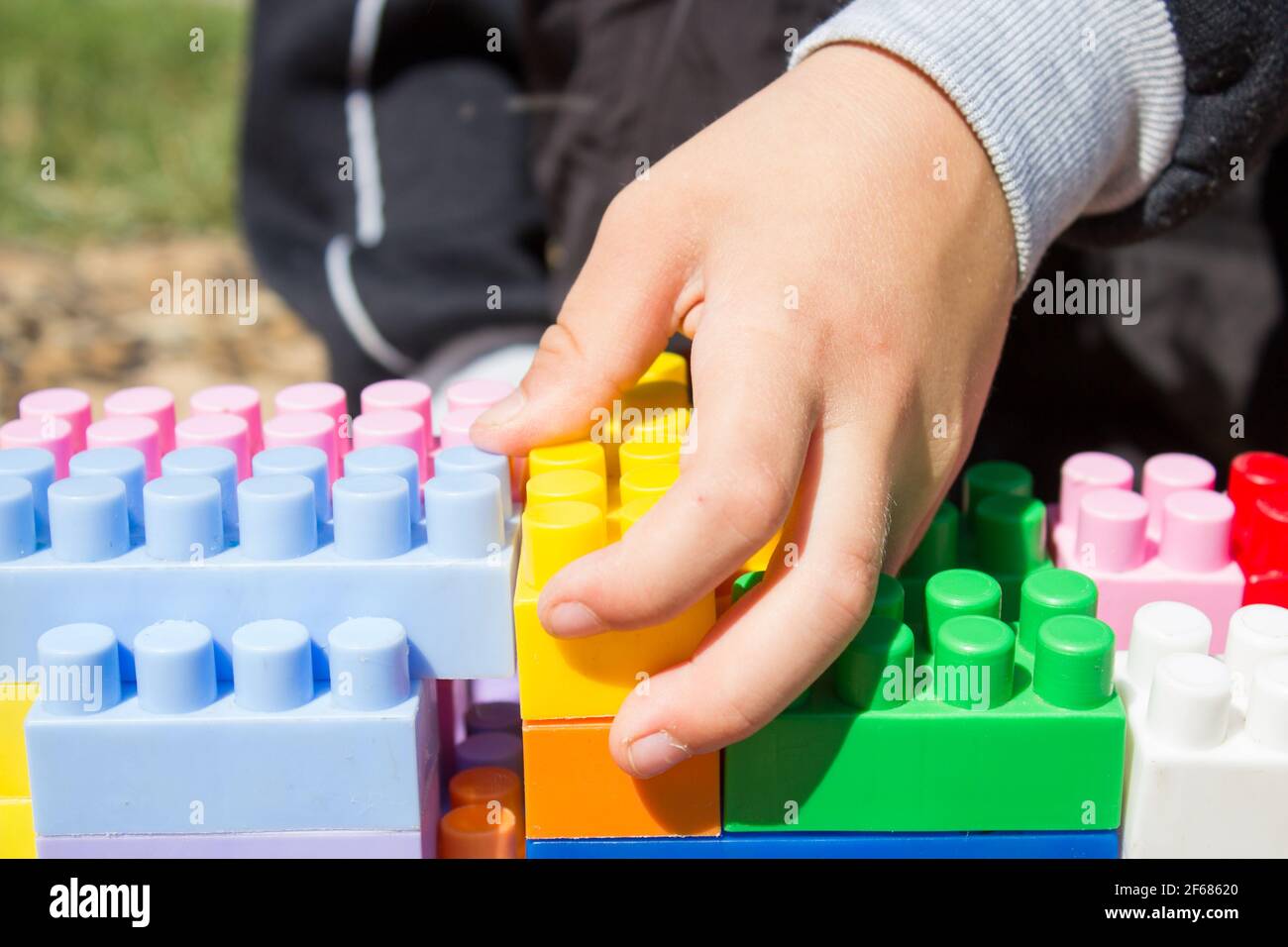 toy Designer children's hand is close-up, hand hold Stock Photo