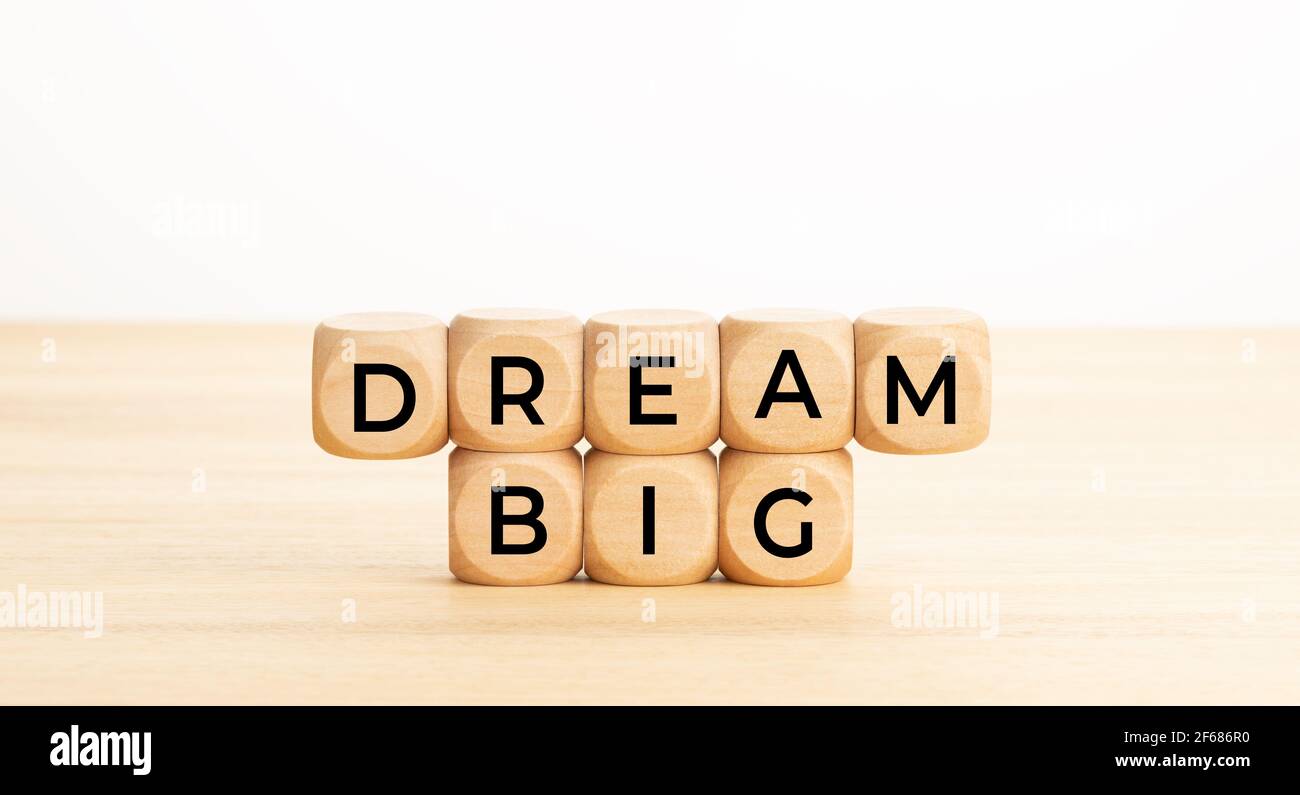 Dream big concept. Word on wooden blocks on table. White background. Copy space Stock Photo