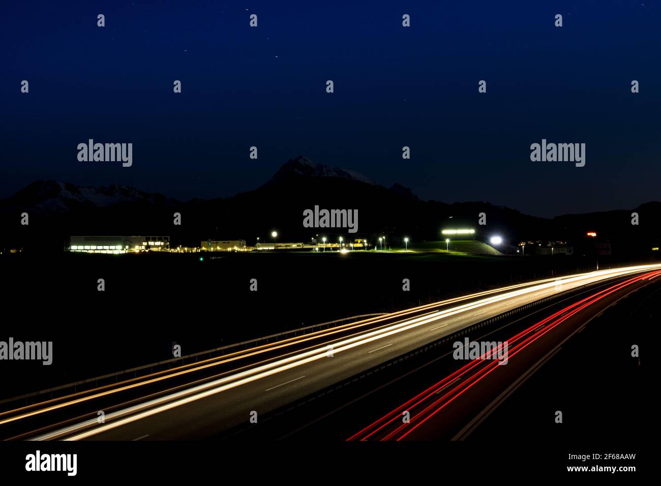 Long exposure shot of an highway with vehicle light trail, shot near Bulle, Fribourg, Switzerland Stock Photo