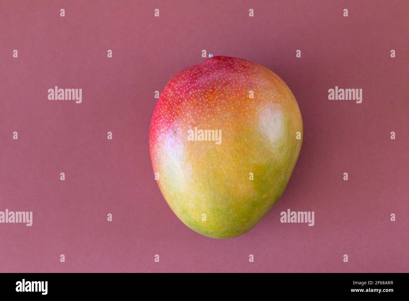 Fresh delicious mango isolated on brown background Stock Photo