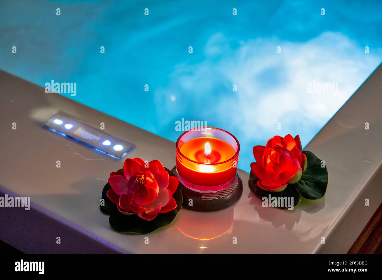 Hot tub with candles and water lilies Stock Photo Alamy