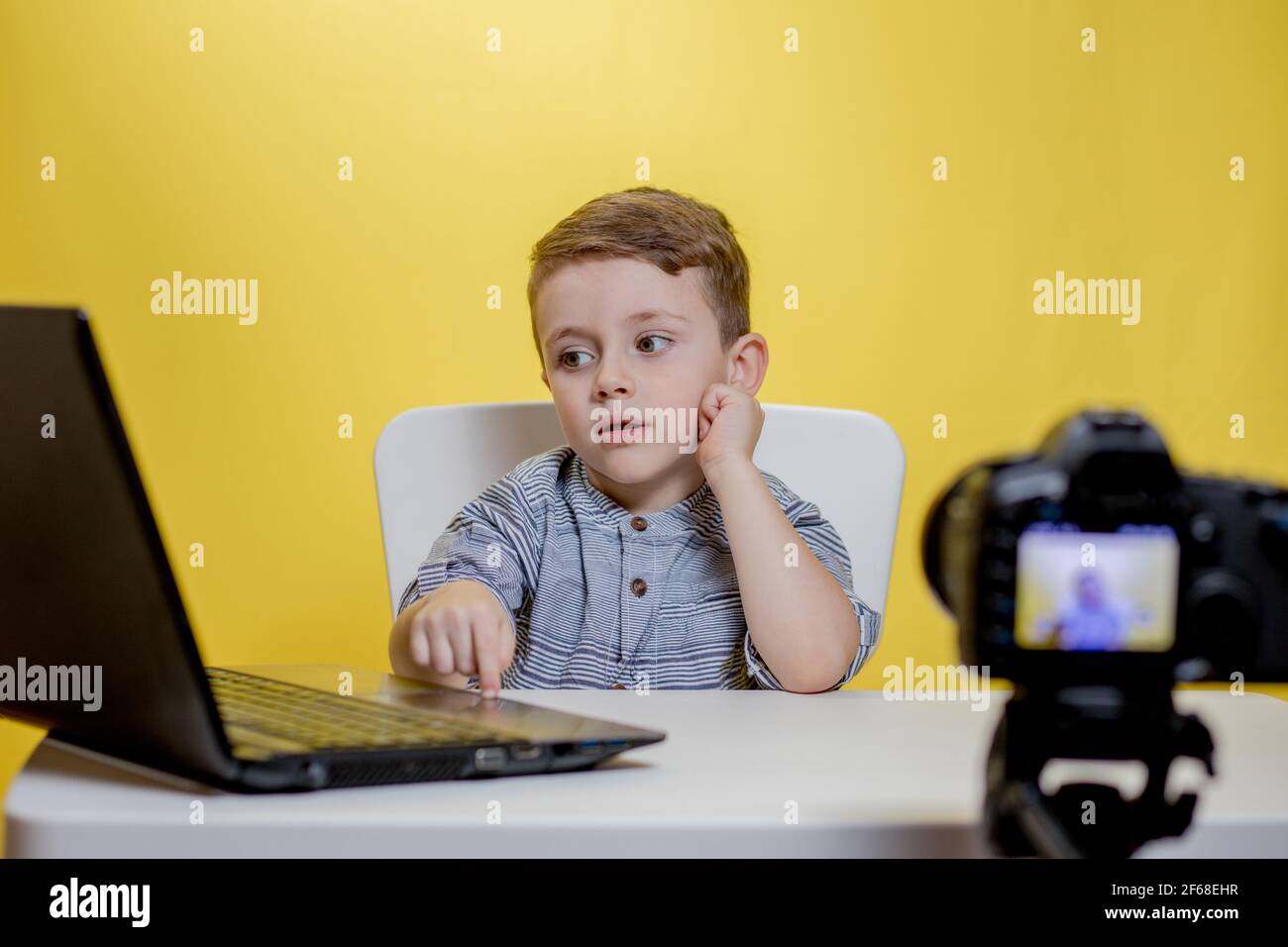 Kid blogger filming video on camera working with the laptop Stock Photo ...