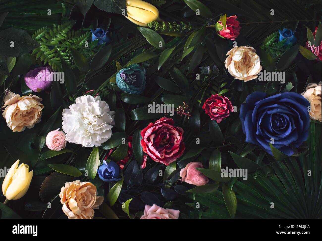 Creative arrangement  with colorful flowers and green leaves. Nature flat lay  concept or greeting card. Stock Photo