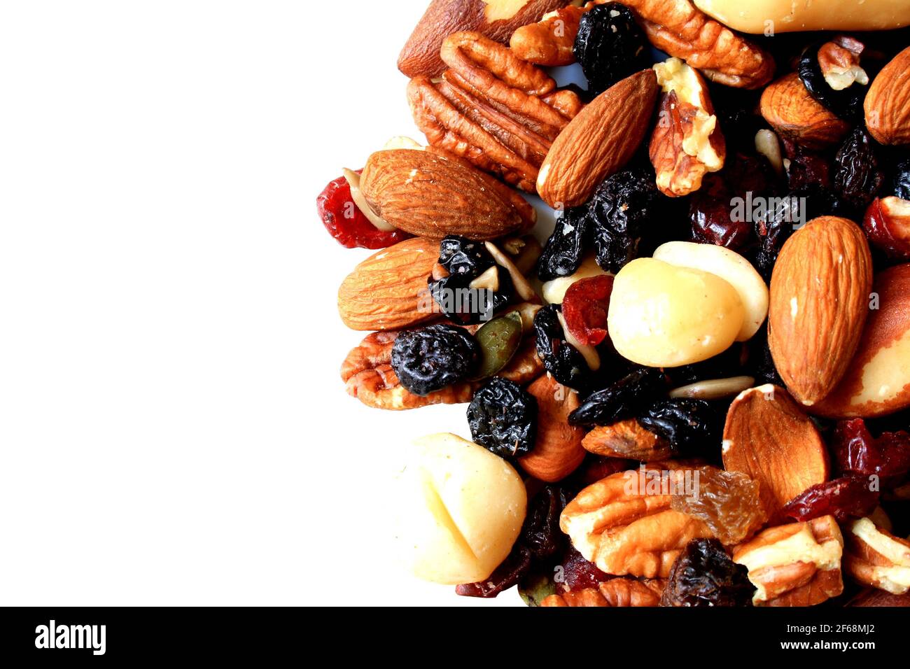 A heap of almonds, macadamia nuts, pecan nuts, raisins, sunflower seeds, sultanas, dried cherries, pumpkin seeds, Brazil nuts and dried cranberries Stock Photo