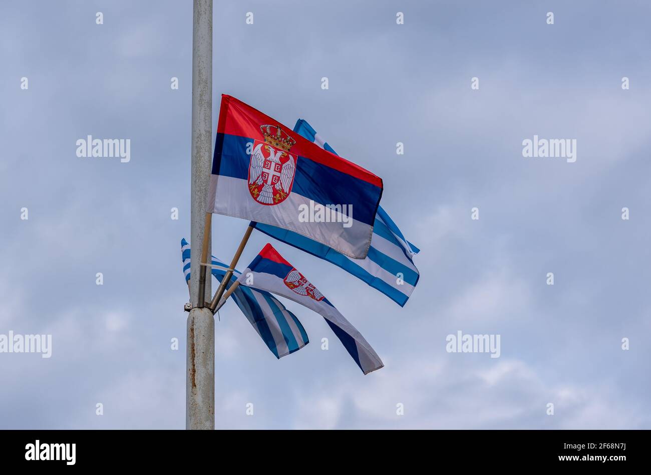 Flags of the Republic of Serbia and Greece on a pole in Belgrade, capital of Serbia Stock Photo