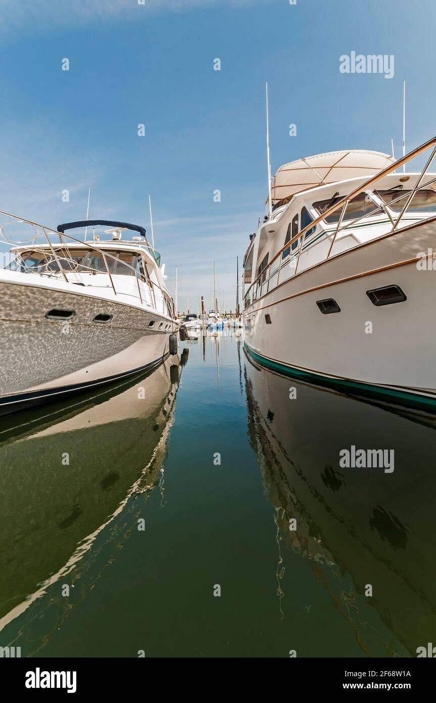 The calm space between two power boat yachts at the Port of Anacortes