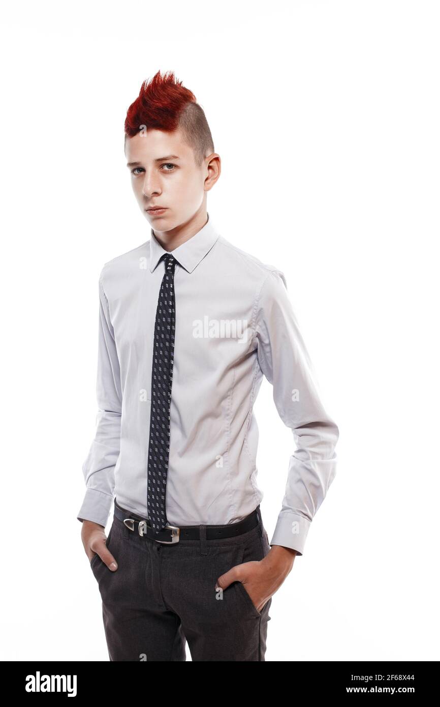 Portrait of serious teen with red mohawk wearing shirt and tie while looking at camera. Isolated. Stock Photo