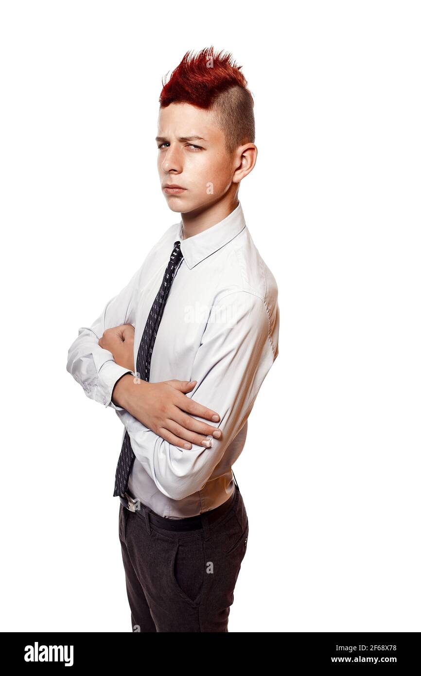 Portrait of serious teen with red mohawk wearing shirt and tie while looking at camera. Isolated. Stock Photo