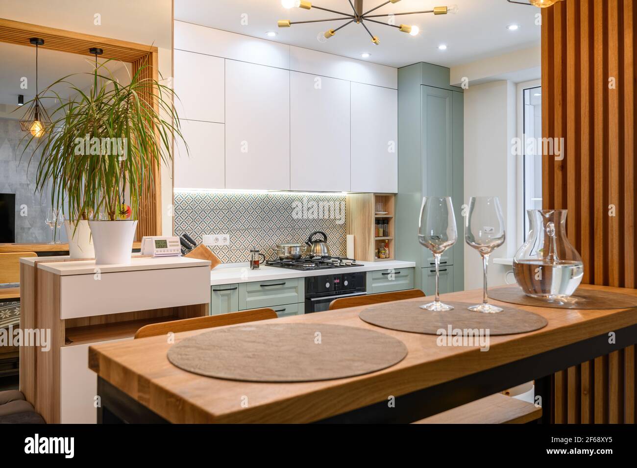 Modern classic white kitchen interior with dining zone Stock Photo - Alamy