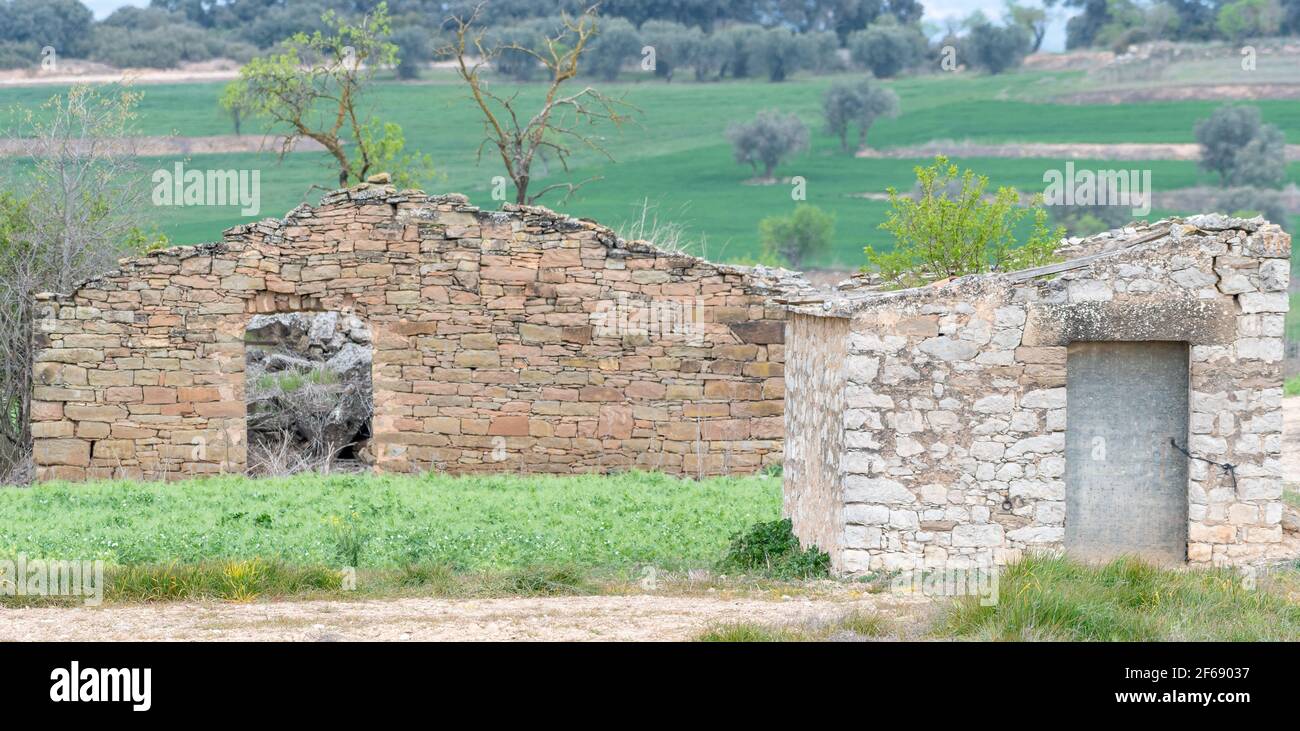 front view of an old farmer's hut made of stone, abandoned and in ruins. Stock Photo