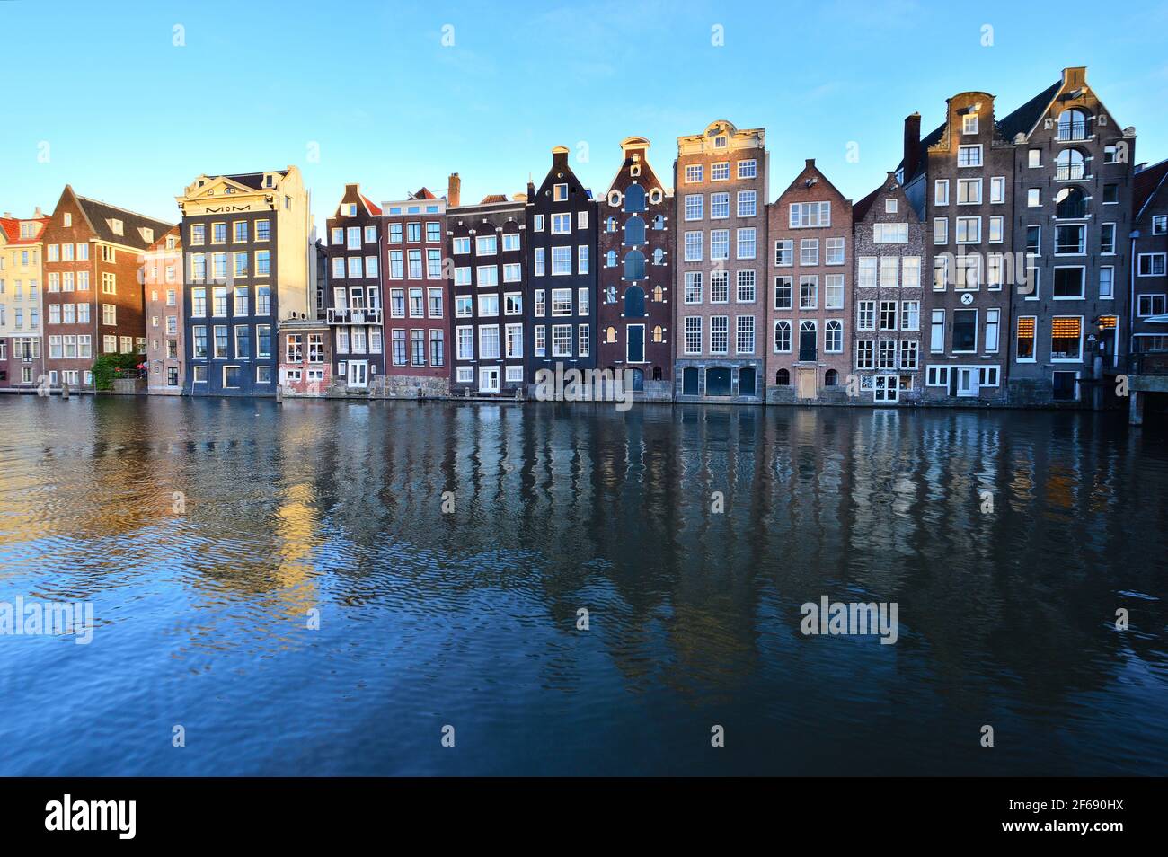 Historic houses in Amsterdam on the Amstel River. The Netherlands. Day. Stock Photo