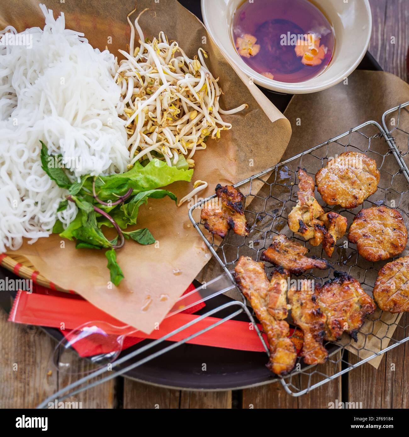 Street food, plate of soup, broth, rice noodles, soy sprouts and ...