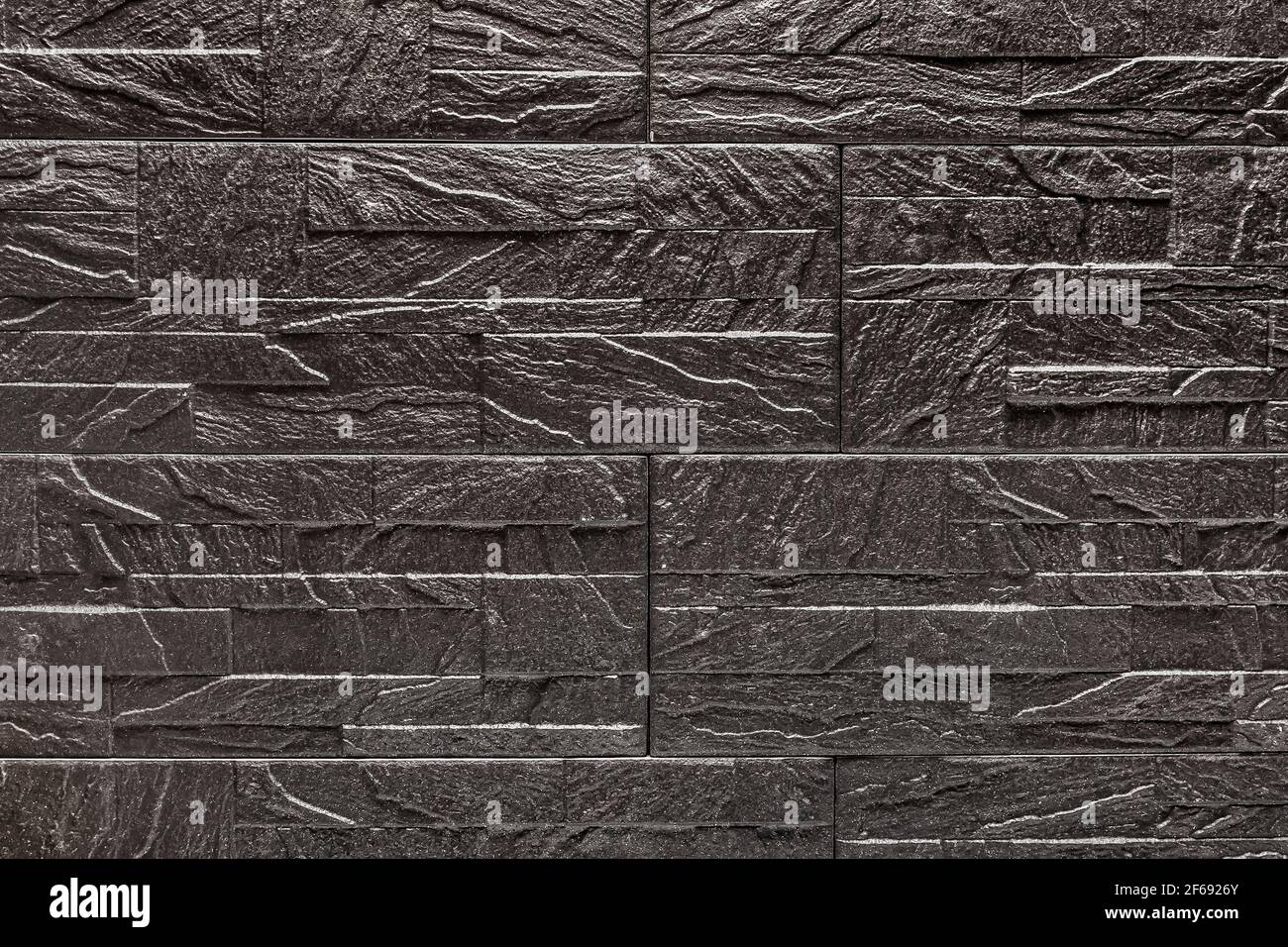 Black decorative stone tile texture with abstract patterns background