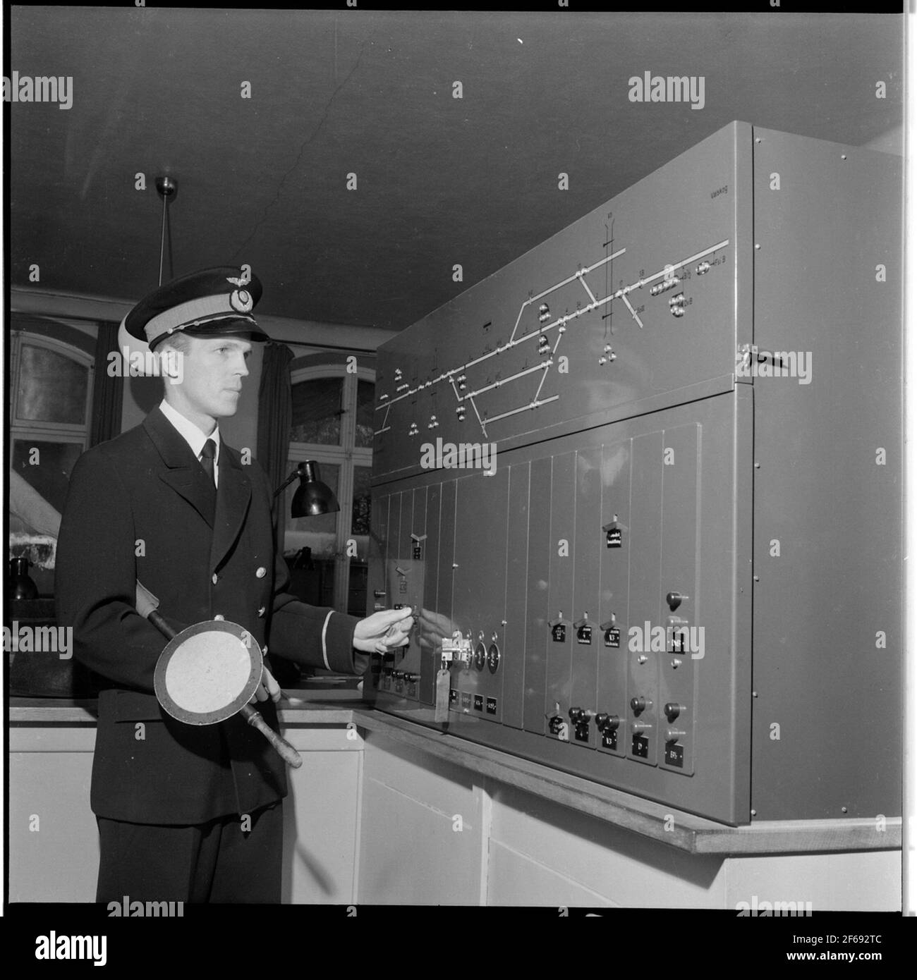 Railway official at electrical switchgear Stock Photo Alamy