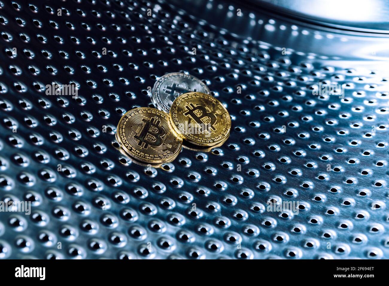 Bitcoins inside a washing machine, concept of fraudulent money laundering  with cryptocurrencies Stock Photo - Alamy