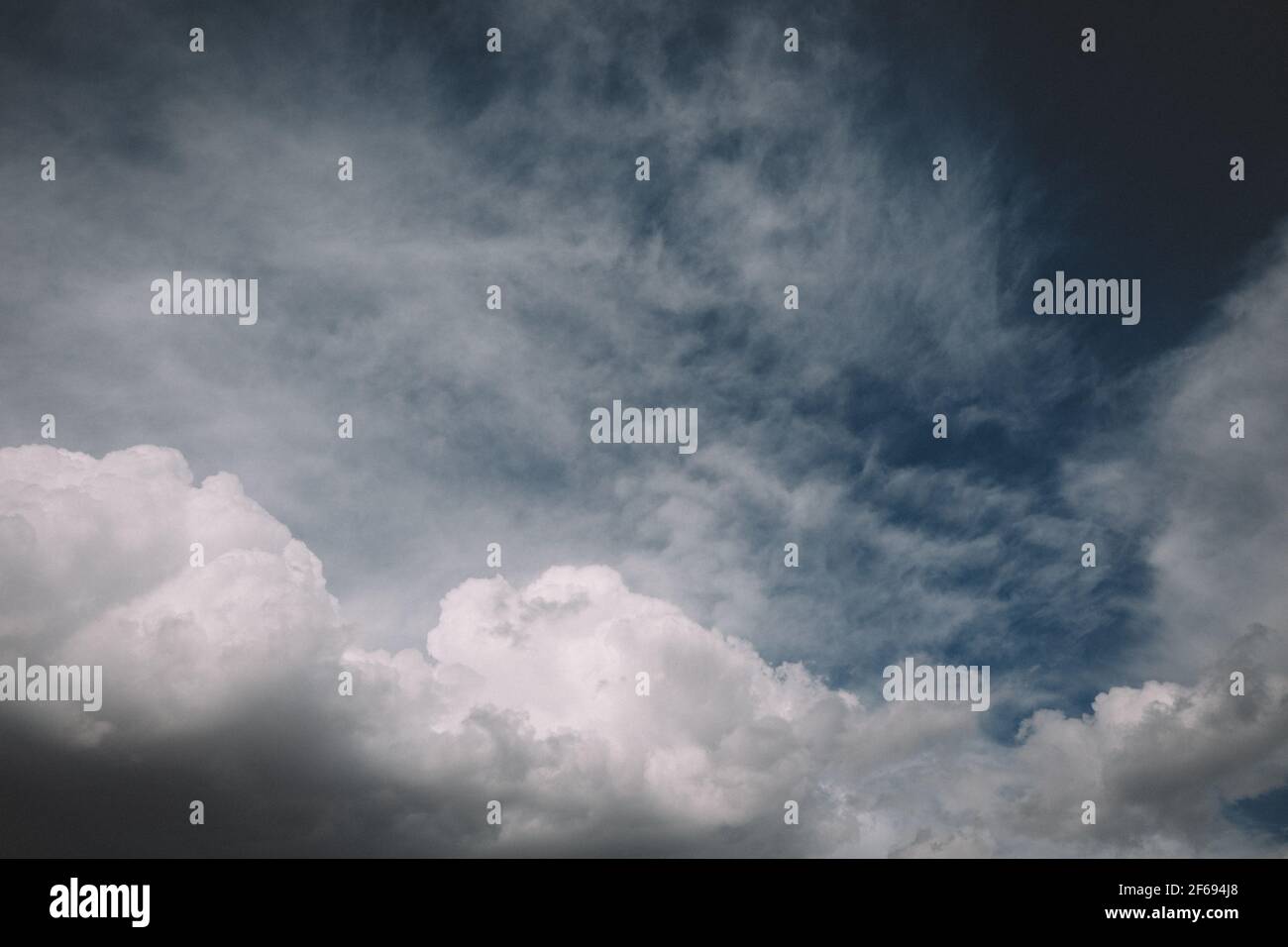 Dramatic White Puffy Clouds against a Blue Sky Stock Photo