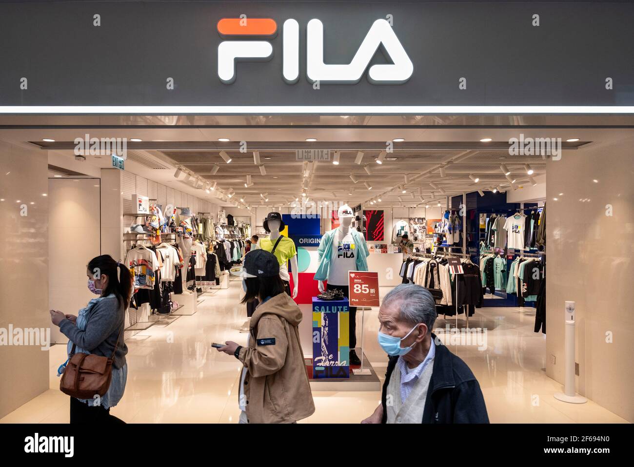 Hong Kong, China. 30th Mar, 2021. Pedestrians walk the Italian sporting brand, Fila store