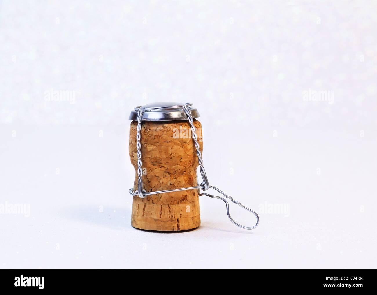 Champagne cork with white snowy bokeh with text space for congratulations. Stock Photo