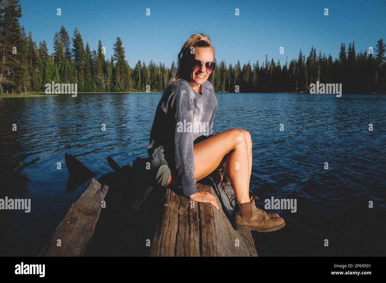 Blonde Woman is Relaxed at High Sierra Lake in California Stock Photo