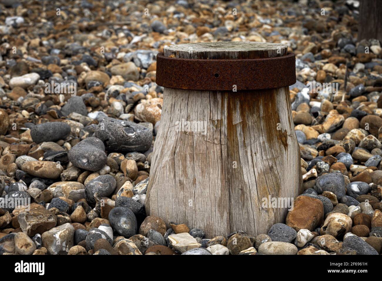 close-up of a wooden and metallic groyne on Eastourne shingle beach, England Stock Photo