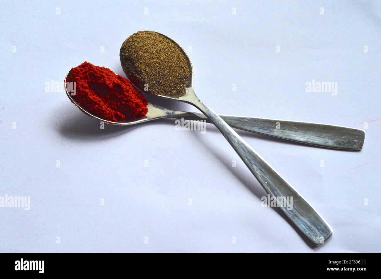 spices in spoons on white background Stock Photo