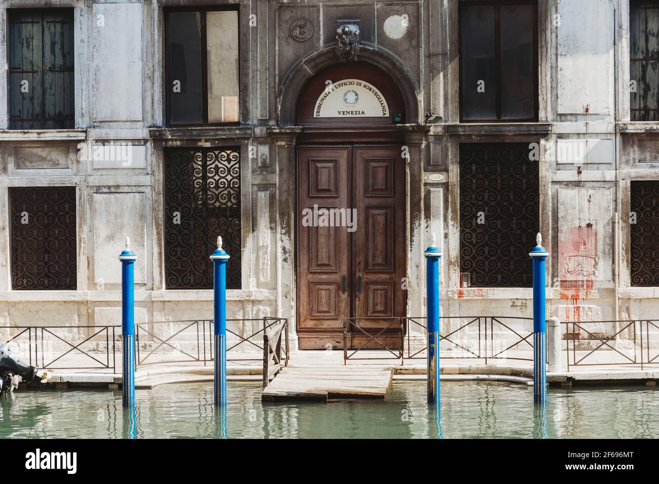 Waterfront property with double wooden door in Venice Italy Stock Photo