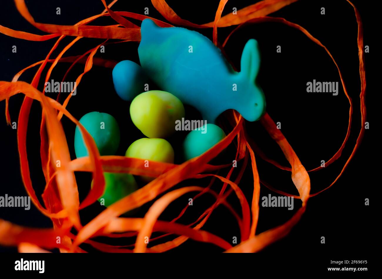 Easter decor with orange ribbon on black background Stock Photo