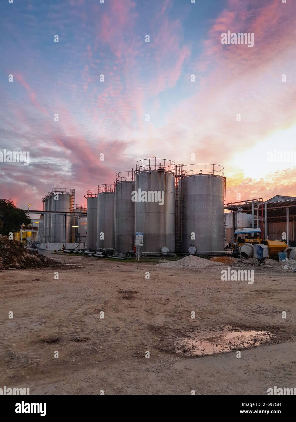 Large metal silo for storing raw material. Modern industrial plant. Stock Photo