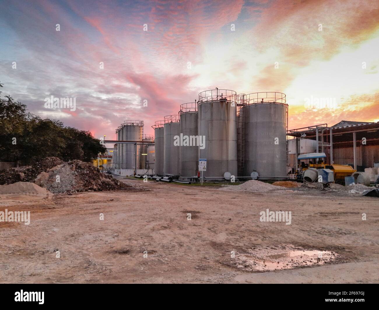 Large metal silo for storing raw material. Modern industrial plant. Stock Photo