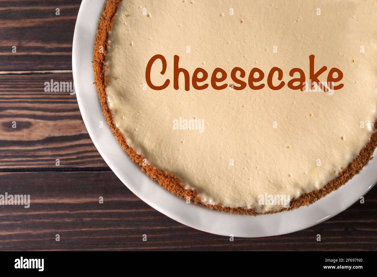 Cheesecake in a baking dish. Classic cheesecake in New York style on wooden background. Stock Photo