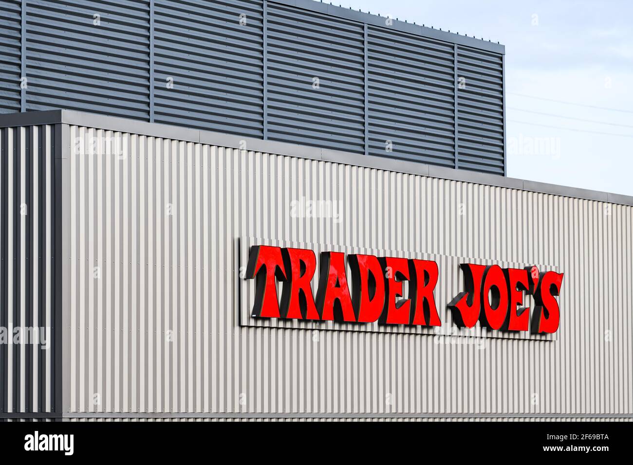 Bellevue, WA, USA - March 30, 2021; Company sign at a Trader Joe's business location in Bellevue Washington on a pale colored container Stock Photo