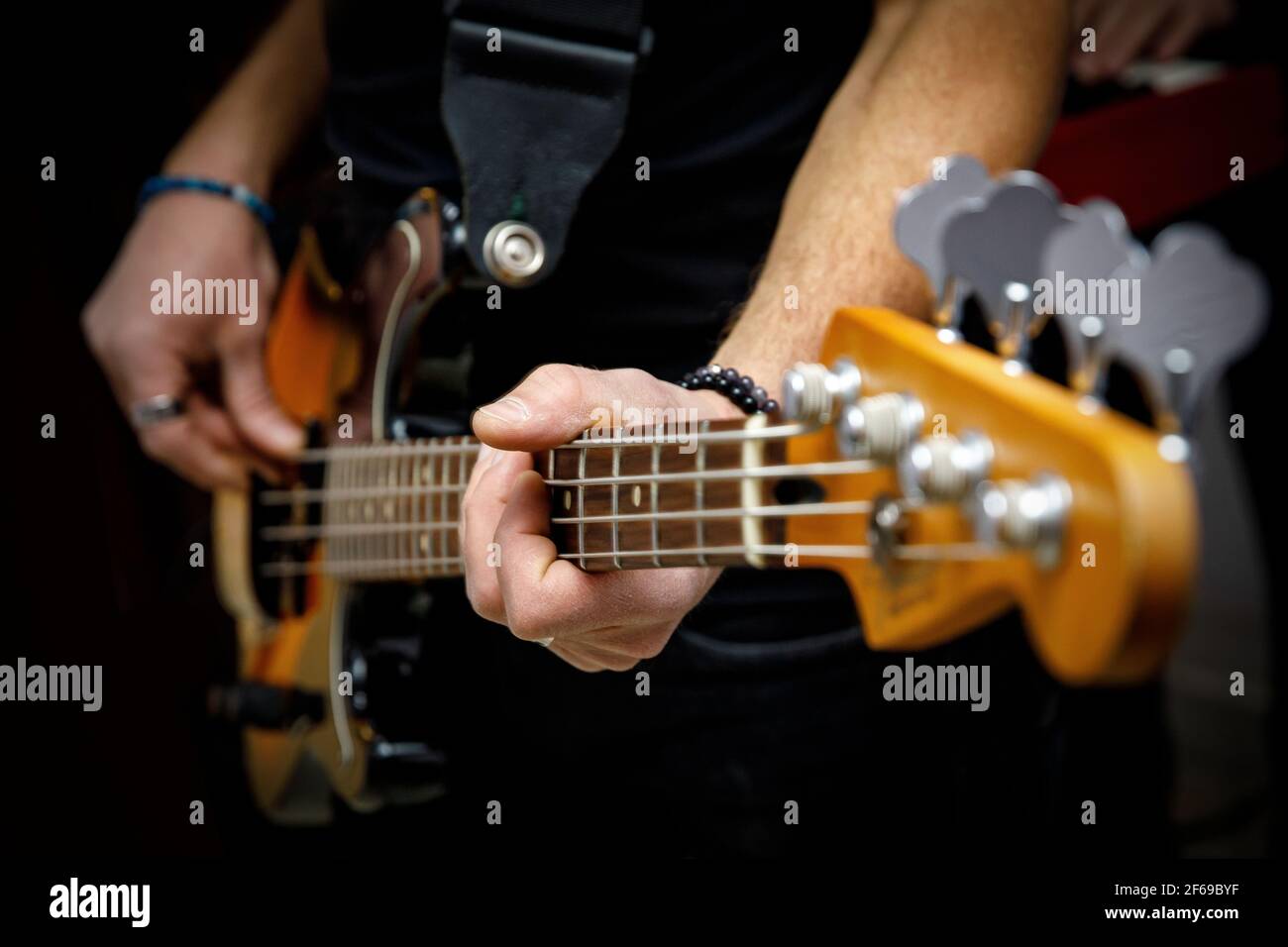 Bassist playing electric bass guitar Stock Photo Alamy