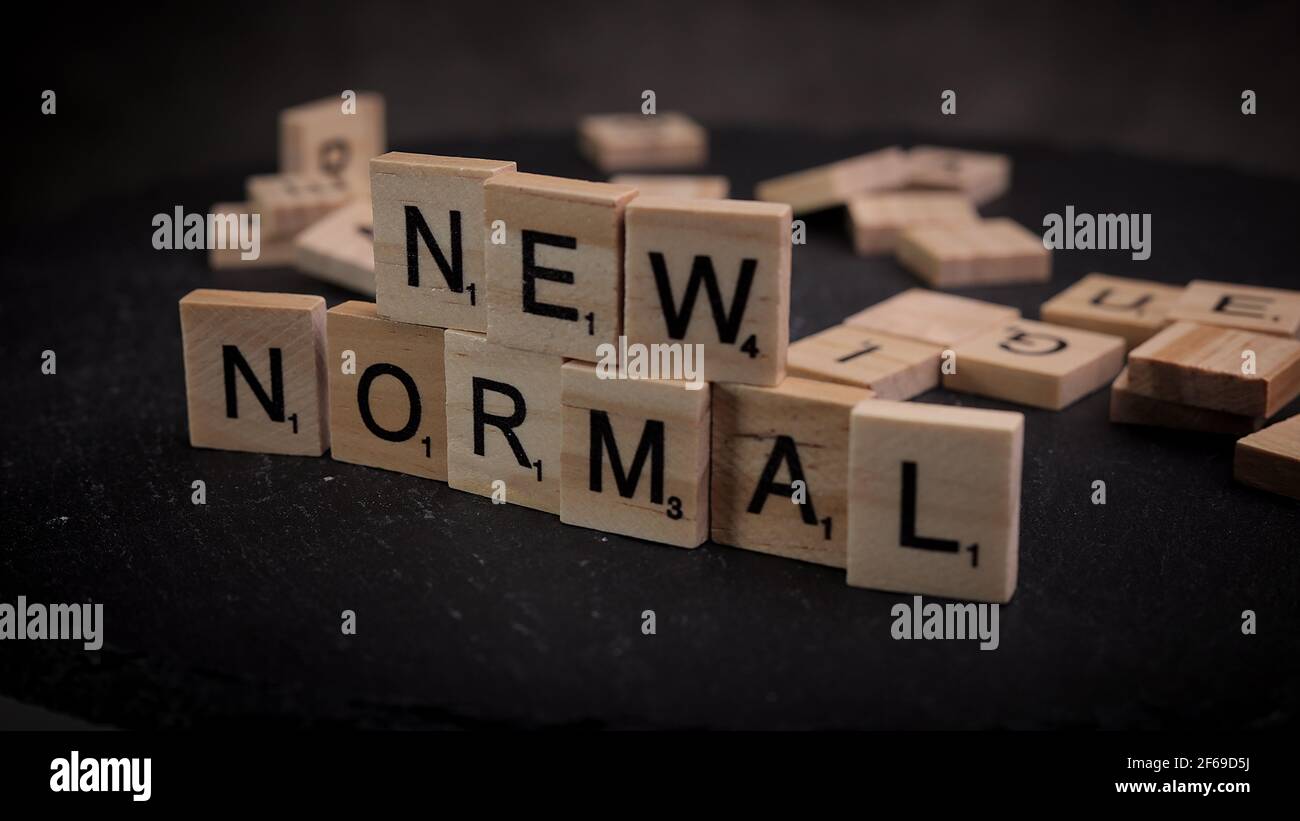 The words New Normal written on wooden letter cubes Stock Photo - Alamy
