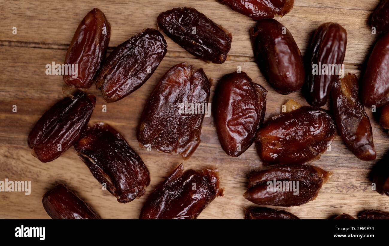 Dried dates on a wooden board Stock Photo - Alamy