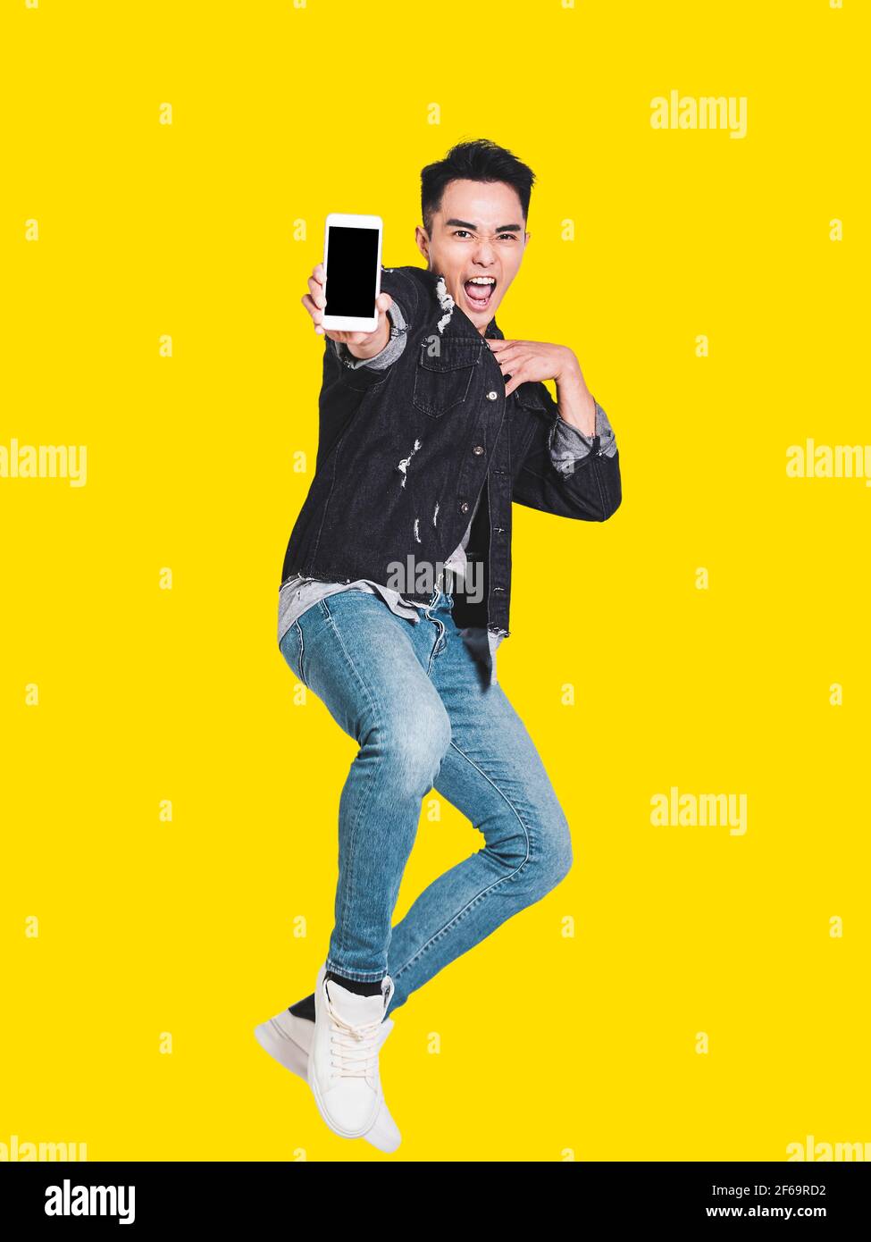 Happy handsome young man showing the smart phone and jumping Stock ...