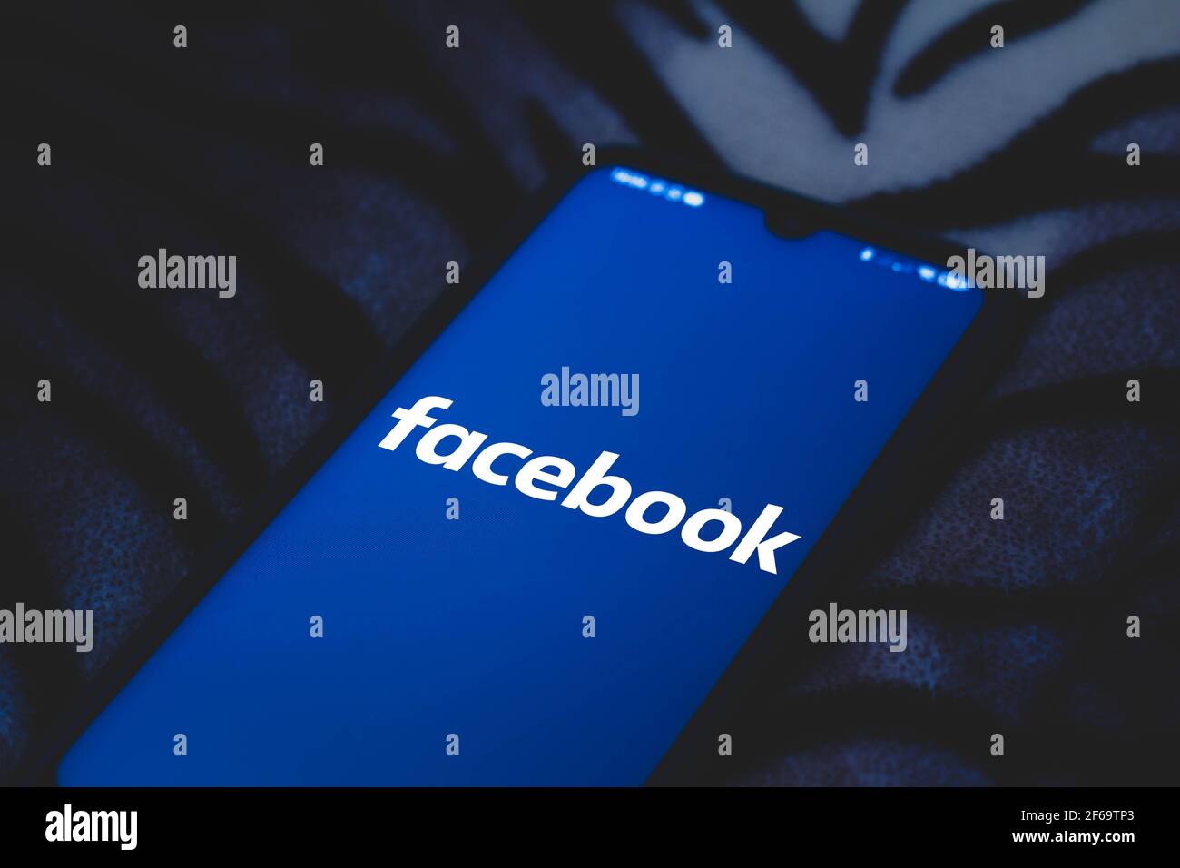 In this photo illustration Facebook logo seen displayed on a smartphone ...