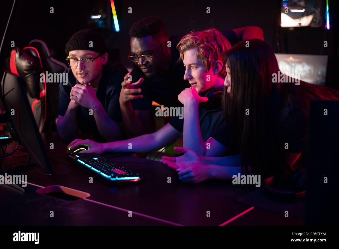Players of the esports team gathered together in the computer club and watch the stream from the dota 2 world championship Stock Photo