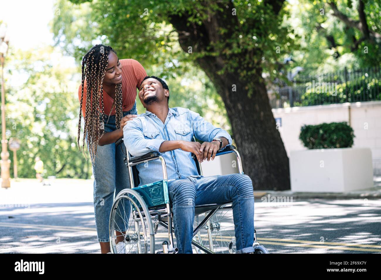 Man in a wheelchair enjoying a walk with his girlfriend Stock Photo - Alamy
