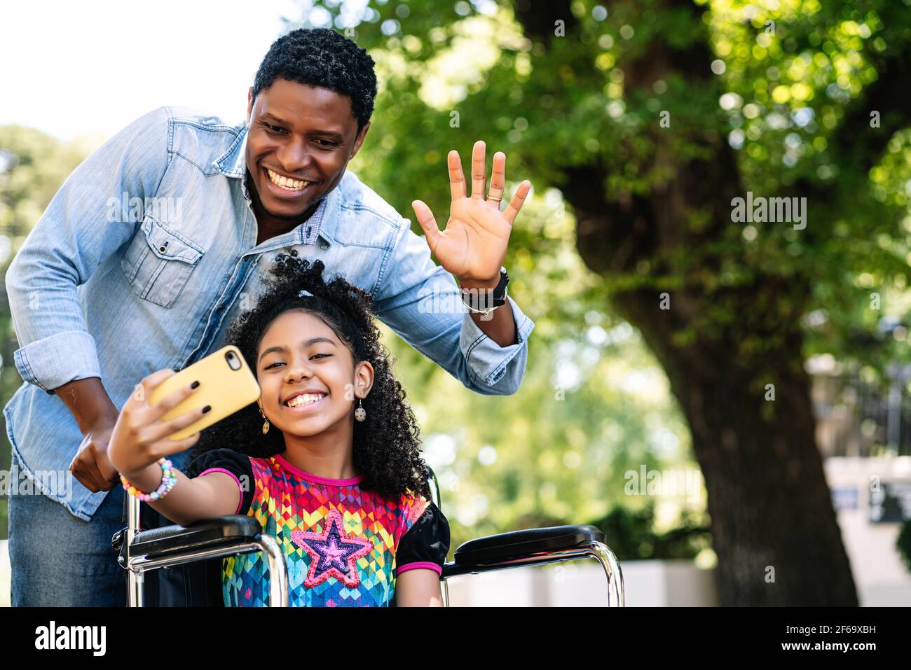 Girl in a wheelchair and her father taking a selfie with phone Stock ...
