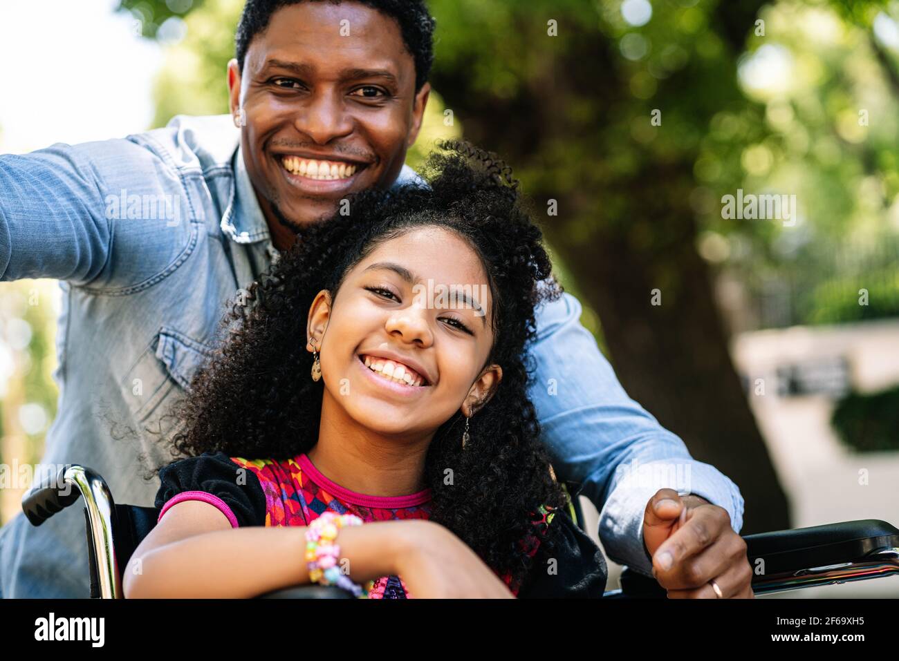 Little girl in a wheelchair taking a selfie with her father Stock Photo ...