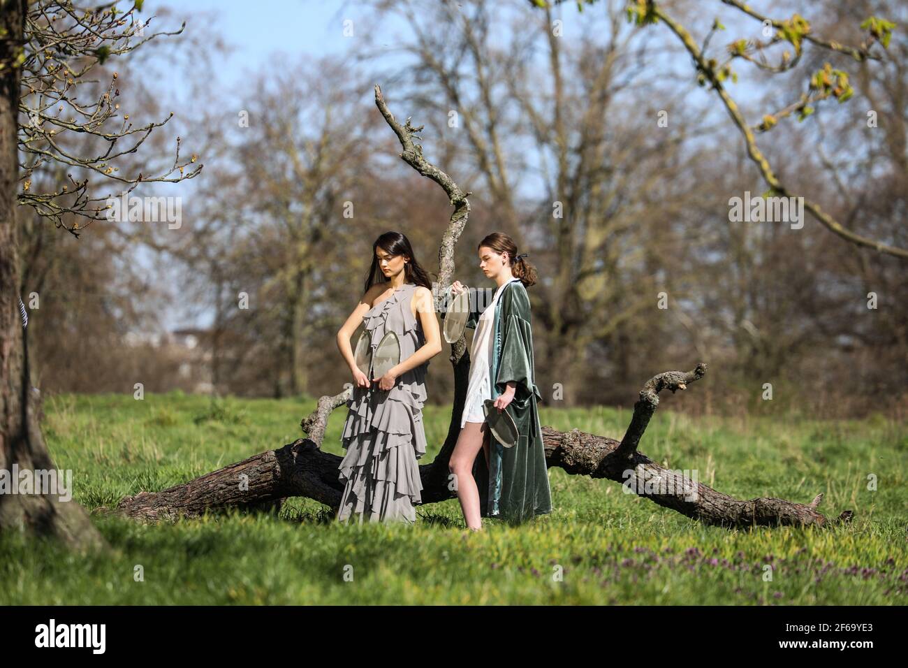 women-pose-for-photos-at-a-park-on-the-hottest-day-of-2021-so-far-stock
