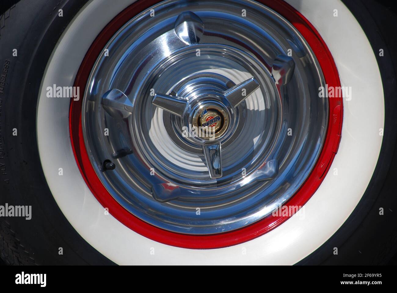 Hubcap of a 1964 Chrysler with whitewall tires. Stock Photo