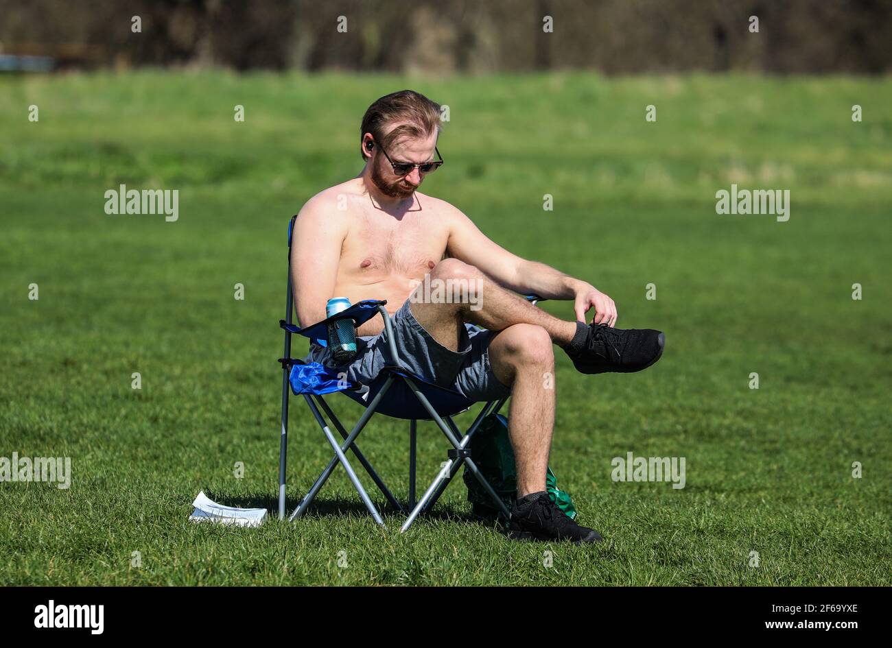 a-man-seen-sitting-on-a-fold-up-chair-while-enjoying-the-sunshine-on