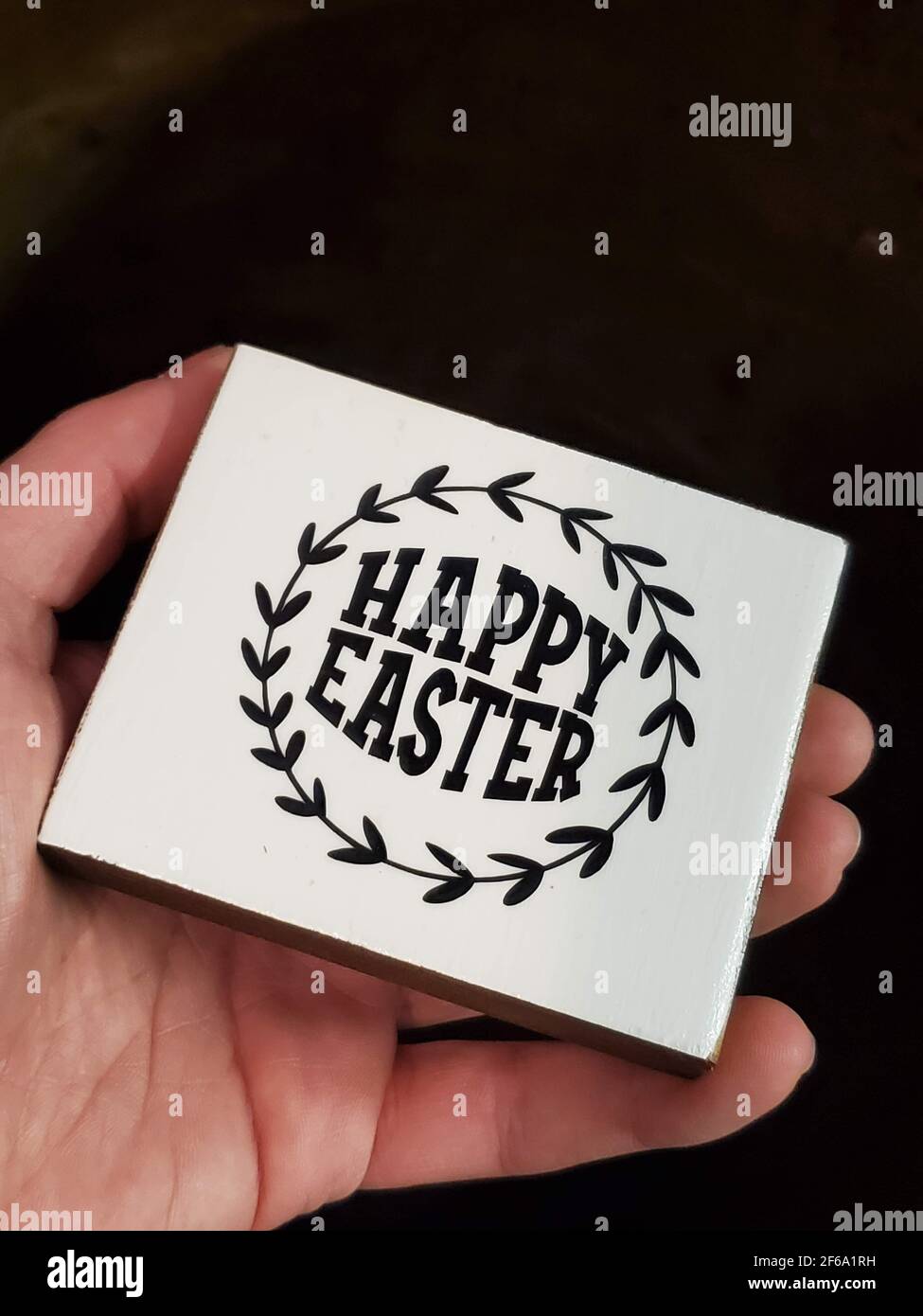 Small Decorative Sign With Words "Happy Easter", Held in a Hand Stock Photo