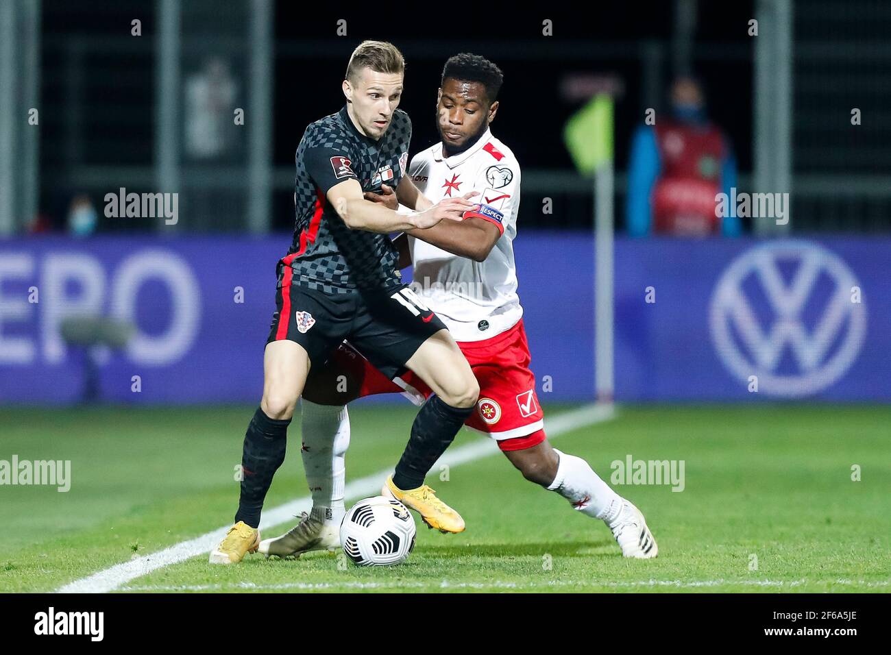 210331) -- RIJEKA, March 31, 2021 (Xinhua) -- Mislav Orsic (L) of Croatia  vies with Joseph Mbong of Malta during the FIFA World Cup 2022 qualifying  match between Croatia and Malta in