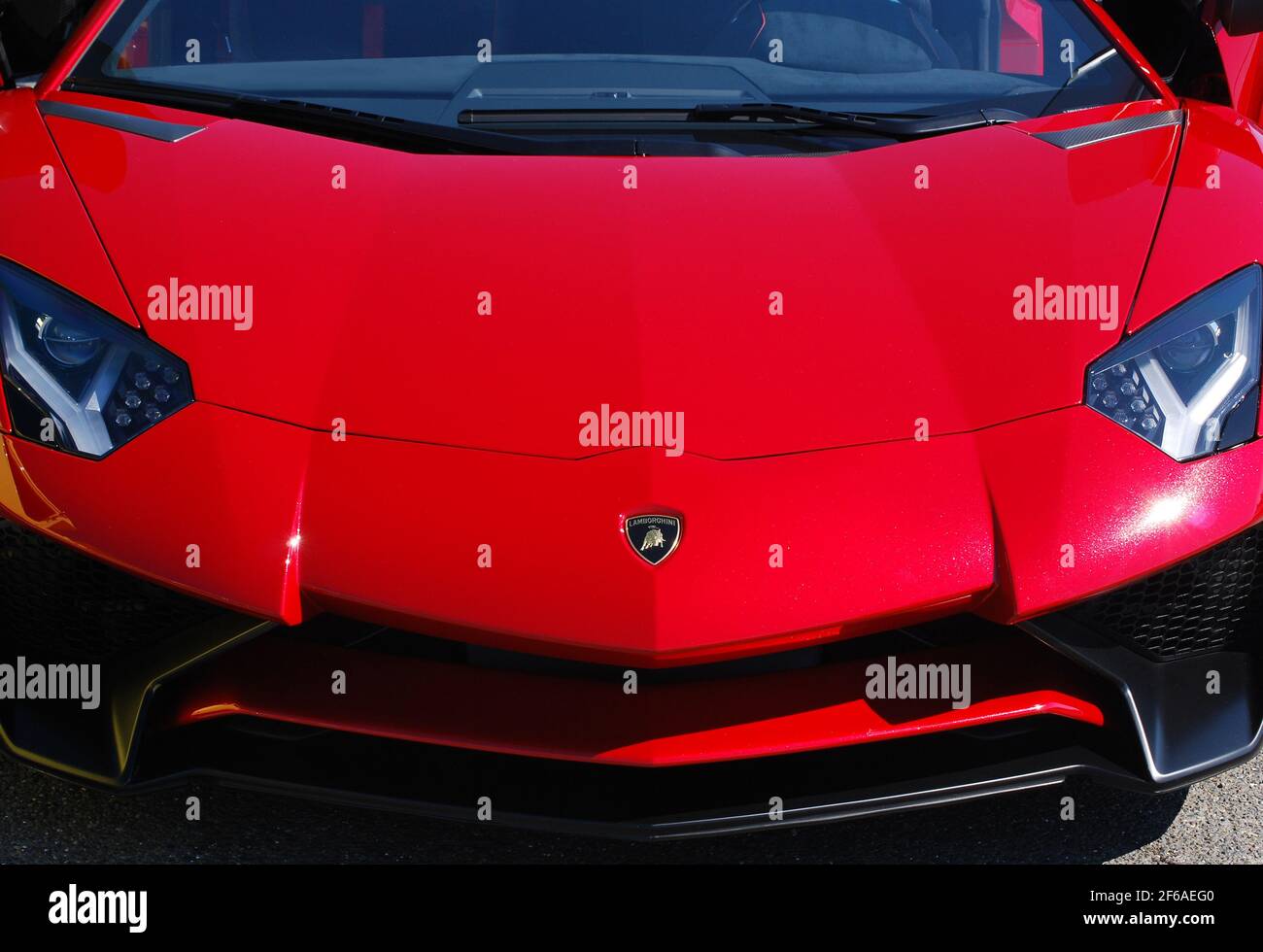 A red, 2012 Lamborghini Aventador hood detail with emblem Stock Photo